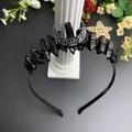 Detail of Gothic crown headband with black crystals and silver crescent moon on Roman pillar - Black