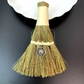 Close-up of handmade straw broom with a vintage silver sun pendant on dark background - Vintage Silver Sun Shape Style (10)