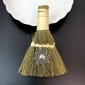 Detailed close-up of decorative straw broom with silver sun pendant and leather handle - Sun Pattern Style (09)