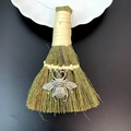 Close-up of decorative straw broom featuring a vintage silver bee metal charm detail - Vintage Silver Bee Style (05)