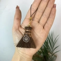 Handheld view of a mini broom ornament featuring a silver sun charm and copper wire wrap - Broom with Sun Charm