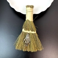 Detail of mini straw broom with silver skull hand pendant on black background - Vintage Silver Skeleton Hand Style (29)
