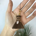 Close-up of handmade broom charm with pink crystal bead and gold metal clasp - Broom with Irregular Rose Quartz