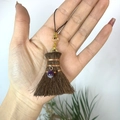 Detailed close-up of handmade broom pendant with purple bead and copper wire wrap - Broom with Amethyst
