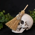 Close-up of miniature witch broom with silver sun pendant and rustic straw fibers - Sun Flower Pendant