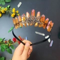 Detail of handmade amber crystal moon crown with intricate black wire wrapping - Brown