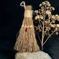 Macro shot of red teardrop gemstone pendant on a vintage straw broom decorative prop - 17x8cm / Red Waterdrop