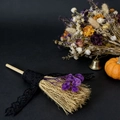 Close-up of decorative lace broom with purple dried flowers for festive table decor - Purple Gypsophila
