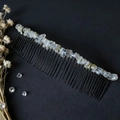 Detailed view of handmade 40-tooth hair comb with raw crystal stones on a dark surface - Rutilated Quartz (40 Teeth)