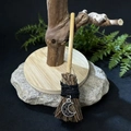 Macro detail of a handmade mini witch broom with wooden handle and silver moon pendant - Broom With Moon