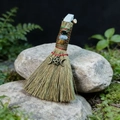 Detailed view of handmade witch besom with natural crystals and pentagram moon charm - Bronze Moon Star + White Pine
