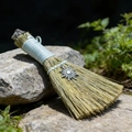 Detail of a handmade altar besom with natural dried grass and metal sun pendant charm - Smoky Quartz And Silver Sun