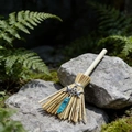 Close-up of witch altar broom with blue crystal and silver moon charm on a mossy rock - 13cm / Triple Moon + Blue Crystal
