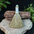 Macro detail of witch broom with crystal gemstone and moon pendant for altar decor - Fluorite And Crescent Face