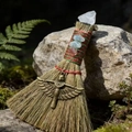Altar witch broom with white crystal, goddess Isis pendant, and red-green twine handle - Cross + White Crystal
