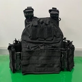 Detail of black tactical vest featuring MOLLE system and three magazine pouches - One Size / Black