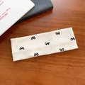 Diadema elástica crema con lazos negros y suave textura de punto acanalado fino - Blanco