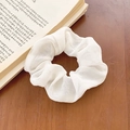 White floral chiffon hair scrunchie with high elasticity on a rustic wooden background - White