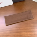 Elastic wide knit dark brown sports headband for yoga and fitness on wood background - Coffee