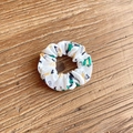 White fabric scrunchie with green cup and figure prints on a rustic wooden table - Cup Character (10#)