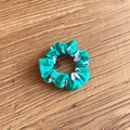 Turquoise scrunchie with white football patterns on a light brown wooden background - Turquoise Soccer (19#)