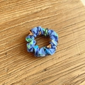Blue fabric scrunchie with football motifs and letter prints on a wooden surface - Blue Letters (24#)