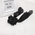 Detail of black satin hair scrunchie with long ribbon bow and delicate edge stitching - Black Streamer Scrunchie