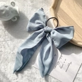 Elegant light blue chiffon ribbon hair tie on white faux fur background with decor - Blue-Grey