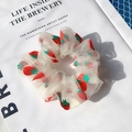 White organza scrunchie with red strawberry print pattern on a fashion magazine - Light Yellow