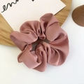 Silky satin scrunchie in dust pink color on a minimalist aesthetic display tray - Ruby Red