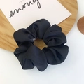 Classic black scrunchie accessory with rich fabric pleats on a minimalist wooden tray - Black