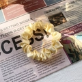 Elastic satin scrunchie in pale yellow with a soft silky texture for ponytails - Beige