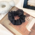 Elegant black organza scrunchie with sheer texture on vintage postcard background - Black