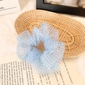 Blue and white gingham organza scrunchie with soft pleats on a decorative background - Grid Blue