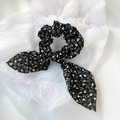 Floral bow hair scrunchie with pink tulip pattern on black fabric for hair styling - Black