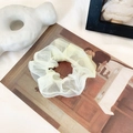 Elegant cream yellow organza scrunchie with fluffy mesh texture on art background - Milk White