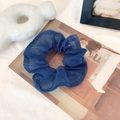 Elegant large navy blue organza scrunchie with a sheer pleated texture on a vintage book - Navy