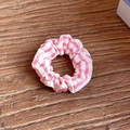 Pink and white striped scrunchie made of pleated fabric on a wooden background - Medium / Pink