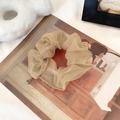 Elegant khaki organza scrunchie with layered pleats on an artistic background - Milk Tea Coffee