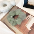 Light green organza mesh scrunchie with soft pleats on a vintage aesthetic background - Grey Green