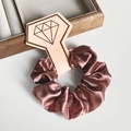 Elegant bronze silk satin scrunchie with diamond logo tag on a minimalist background - Brown