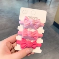 Set aus drei elastischen Haargummis mit rosa Schleifen auf weißer Displaykarte - Rosa