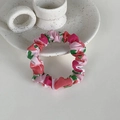 Close-up of pink floral pattern scrunchie hair tie on white ceramic plate - Pink Apple