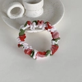 Close-up of a white fabric scrunchie with cute strawberry floral patterns on ceramic tray - Red Strawberry