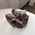 Close-up of a large coffee brown satin scrunchie showing glossy silk texture on white surface - Gray Purple