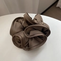 Macro detail of brown satin silk scrunchie with elegant ruffled flower texture - Brown Grey