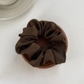 Detailed macro view of chocolate brown satin hair scrunchie with elegant pleated fabric texture - Medium / Dark Coffee