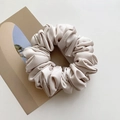 Elegant cream-colored satin scrunchie with a glossy finish and pleated texture - Grey/White