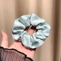 Minimalist silk-like mint green scrunchie with elegant folds and glossy satin finish - Cyan