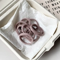 Set of seamless high-elastic hair ties in dusty rose color on a minimalist tray - Light Pink